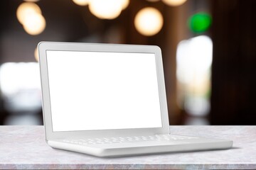 Laptop with a blank screen on table in cafe