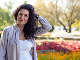 A young girl is resting in the park. Street portrait of a happy woman.