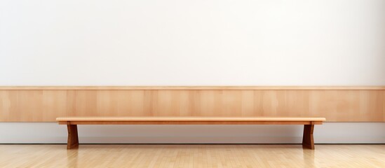 Wooden bench in empty school gymnasium against blank white wall