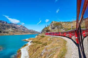 Red train of Bernina in the Swiss alps - 653777683
