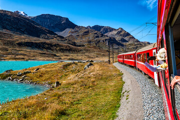Red train of Bernina in the Swiss alps - 653777841
