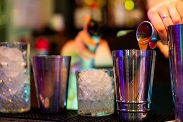 woman hand bartender making cocktail in glass on the bar counter