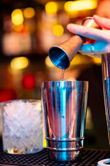 woman hand bartender making cocktail in glass on the bar counter