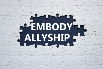 Embody Allyship symbol. Concept word Embody Allyship on white puzzle. Beautiful dark blue background. Business and Embody Allyship concept. Copy space