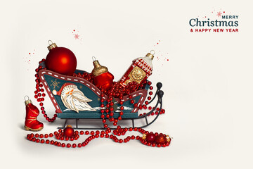 New Year's Christmas decor sleigh with red Christmas tree toys on a white background isolated. Greeting card. Postcard for congratulations on the New Year and Christmas holiday.