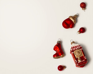 Red New Year's Christmas toys on a white background. Glass boot, mitten and watch for decorating the Christmas tree. Toys isolated.