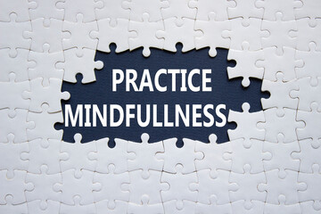 Practice Mindfulness symbol. Concept words Practice Mindfulness on white puzzle. Beautiful dark blue background. Medical and Psychology and Practice Mindfulness concept. Copy space.