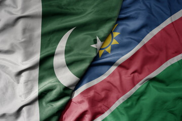 big waving realistic national colorful flag of pakistan and national flag of namibia .