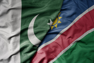 Obraz premium big waving realistic national colorful flag of pakistan and national flag of namibia .