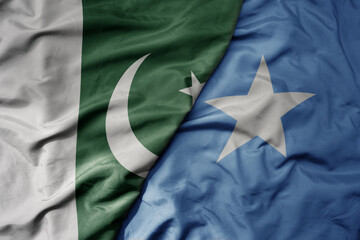 big waving realistic national colorful flag of pakistan and national flag of somalia .