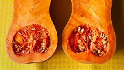 Pumpkin is cut in half. Sliced pumpkin. Pumpkin pulp close-up. Orange vegetable. Diet food concept. Vegetarian food. Selective focus