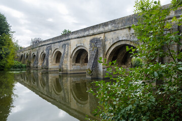 Fototapeta premium Pont du Vernay, 12th century ancient bridge over the river Thouet at Airvault, Deux-Sèvres, Nouvelle-Aquitaine, France