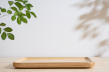 Minimal wood podium table top blurred green leaf plant on white space nature background.Beauty cosmetic natural product display.