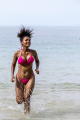 Woman on beach and sand during summer vacation. Beautiful girl on sun tanning in a tropical beach. Female tourist in bikini on sandy beach. Sexy bikini body woman on paradise tropical beach