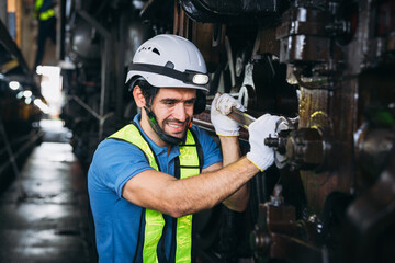 Industrial engineers inspect and perform maintenance on the machines at factory machines. Teamwork in the Manufacturing Industry in the train garage.