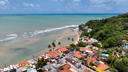 Naklejka premium Scenic cliffs at Pipa Beach in Rio Grande do Norte. Brazil Northeast. Vacations landscape. Paradise scenery. Pipa Beach at Rio Grande do Norte. Scenic cliffs on the beach. Brazil Northeast.