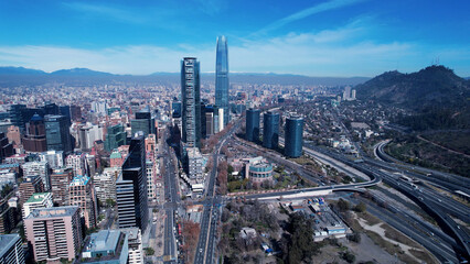Downtown of Santiago Chile in Metropolitan Region. Panning wide landscape of tourism landmark of capital city of Chile. City life scenery with buildings and traffic at avenue near Andes Mountains.
