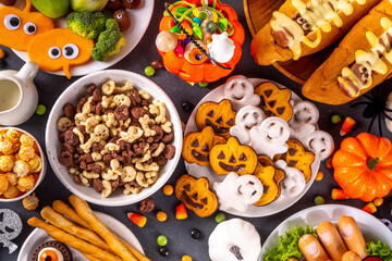 Halloween monster food and snack assortment. Set of funny creative food for children Halloween party, children brunch or breakfast - cookies, healthy and fast food snacks, breakfast cereals, hot dogs