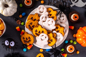 Halloween monster food and snack assortment. Set of funny creative food for children Halloween party, children brunch or breakfast - cookies, healthy and fast food snacks, breakfast cereals, hot dogs