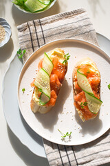 Healthy balanced breakfast: sandwiches with smoked salmon, cream cheese mousse and cucumber. Breakfast in Scandinavian style. Healthy natural quick recipes. Natural beautiful light