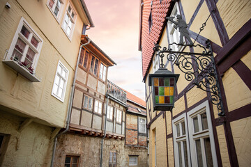 Scenic view old narrow european german town with half-timbered ancient fachwerk houses vintage iron...