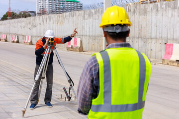 engineer use theodolite equipment working on construction site for route surveying