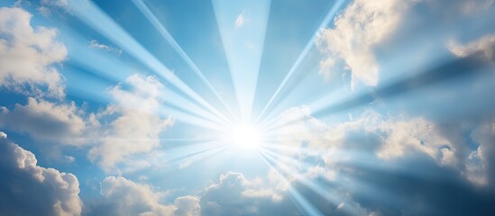 Sunlight bursting through clouds against a blue sky with a spiritual and religious context