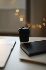 Desk office with laptop, phone, coffee cup, pen on black table. Flat lay top view copy space. Home office. Inspiration moment, workspace or coffee break in the morning. selective focus.