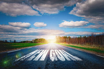 Inscription New Goal written on the road of asphalt.Road at sunset.Concept of...