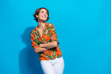 Portrait of minded creative pretty person crossed arms toothy smile look empty space isolated on...
