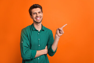 Photo of young man brunet wear orange stylish shirt direct finger mockup presentation check list to do isolated on orange color background