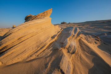 Desert eroded rock pattern with clear sky during the hot sun. Desert rock formation with erosion.
