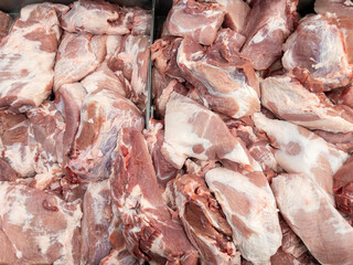 Closeup of fresh pork hip in the metal tray for sale.