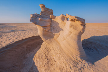 Desert eroded rock pattern with clear sky during the sunset. Desert rock formation with erosion.