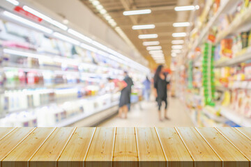 Empty wood table top with supermarket blurred background for product display