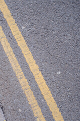Asphalt road with yellow line texture background, closeup of photo