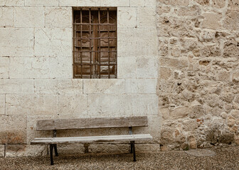 Wall, bench and closed window