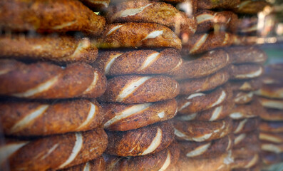 Close up of the stacks famous turkish bagels Simit behind the glass in a cart. Istanbul, Turkey