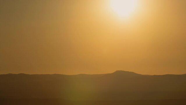 Golden Sunrise over Desert Horizon Timelapse