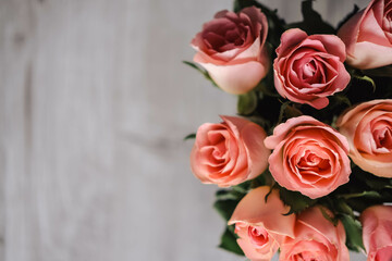 bouquet of pink roses in a vase on a gray background