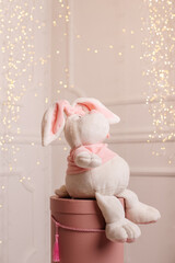 Children's cute magic toy white rabbit looks up, space for text.