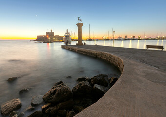 View of the city embankment in night lighting at dawn. Rhodes.
