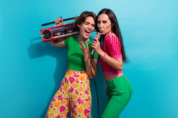 Photo of positive funky girls dressed colorful outfits singing mic listening boom box songs...