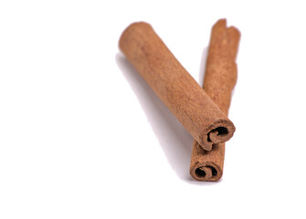 pair of cinnamon sticks next to each other (on top, cut out) isolated on white background (spices, spice, ingredient, flavoring, pie, dessert) indian cooking, spice islands