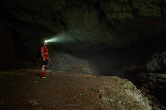 Hiker with backpack exploring a cave
