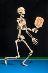 Pickleball skeleton player on black background.