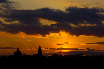 fiery sunset with clouds and silhouette of the cathedral in the foreground