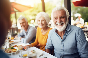 Happy senior friends having fun dining together. Elderly lifestyle people and food concept
