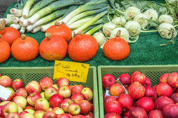 Apples, pumpkins and other vegetables for sale at a market