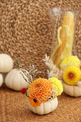 Obraz na płótnie Canvas Small pumpkin with autumn bouquet on table, selective focus